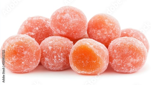 Peach flavored bonbons stacked on a bright white background highlighting their sugary coating and vibrant color photo