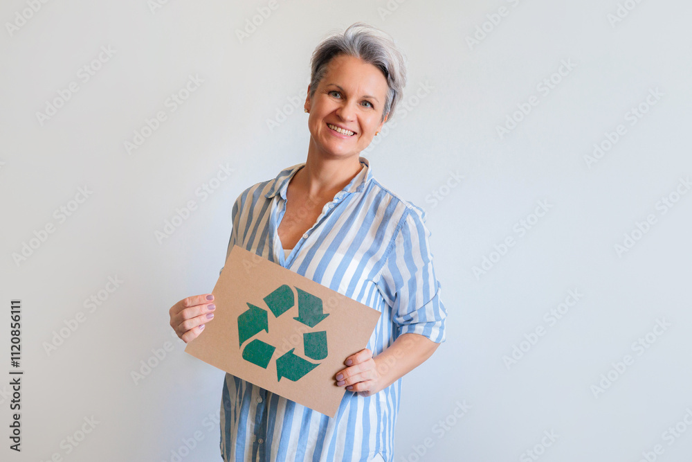 Mature gray haired woman with recycling reusing zero waste signboard isolated on white background Mature gray haired woman with recycling reusing zero waste signboard isolated on white background