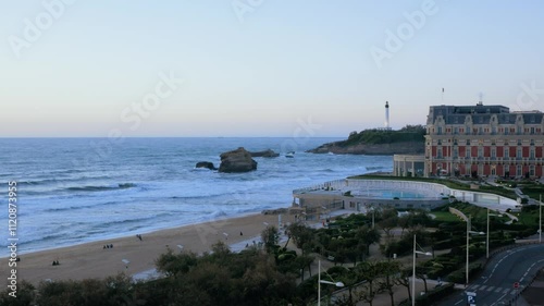 Biarritz coastline with a lighthouse blue sea and waves on a sunset
