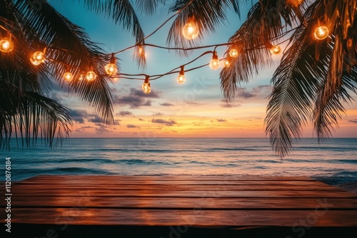 Fototapeta Naklejka Na Ścianę i Meble -  Tropical beach at sunset with wooden table and string lights