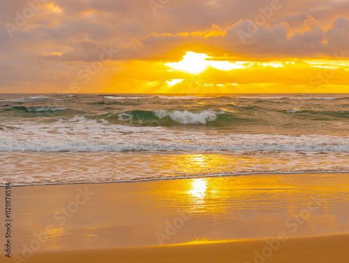 Sunrise Through Clouds on The Sandy Shore of Lydgate Beach, Lydgate Beach Park, Kauai, Hawaii, USA photo