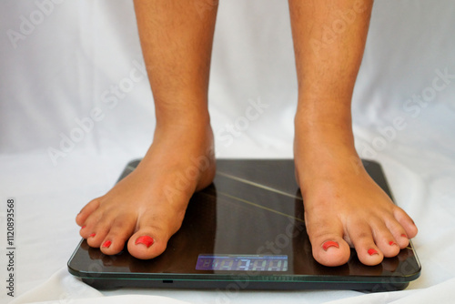 Woman standing on electric weighing scales, lady checking weight loss, barefoot measuring body fat overweight, closeup cropped shot. photo