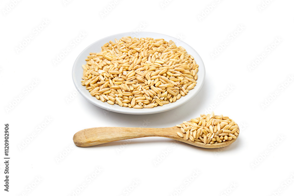 Oat groats on white plate and wooden spoon isolated on white background. Oats contain nutrients that help prevent many diseases, boost immunity, regulate blood sugar levels, and lower cholesterol. Oat groats on white plate and wooden spoon isolated on white background. Oats contain nutrients that help prevent many diseases, boost immunity, regulate blood sugar levels, and lower cholesterol.
