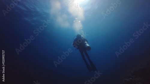 Wallpaper Mural Silhouetted scuba diver ascends in deep blue ocean, bubbles rising. Perfect for illustrating diving, underwater exploration, or freedom concepts. Torontodigital.ca