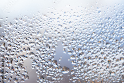View of the window with condensation droplets - water texture