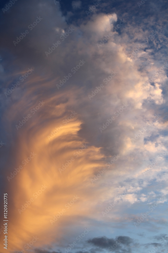 Fototapeta premium Dramatic sky with swirling clouds at sunset abstract textured background