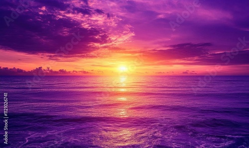 A serene sunset over the ocean, casting vibrant purple and orange hues.