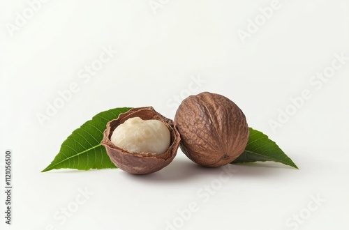 Roasting of shea nuts with green leaves isolated on a white background, studio shot, high-resolution photography nuts and dried leaves