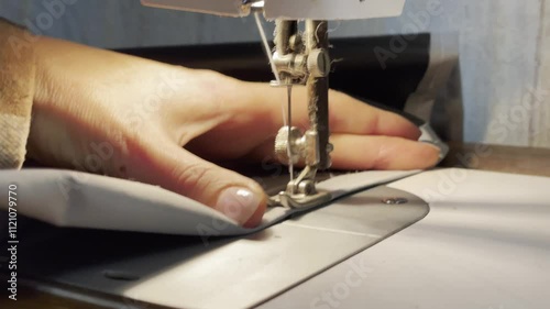 close up of a sewing machine needle in the activity of someone sewing clothes