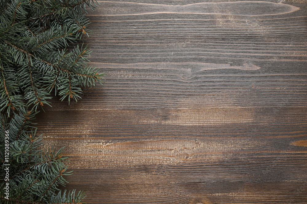 Beautiful fir branches on brown wooden background