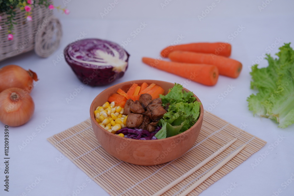A vibrant meal consisting of red rice, meat, corn, carrots, lettuce, and a sunny side A vibrant meal consisting of red rice, meat, corn, carrots, lettuce, and a sunny side