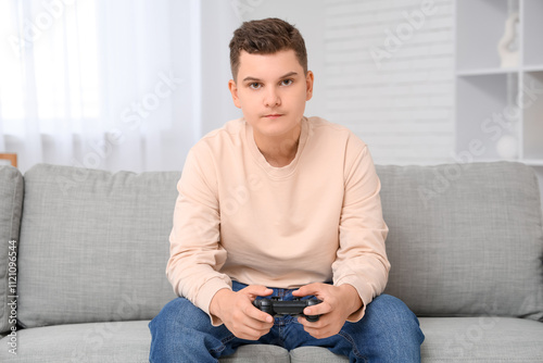 Teenage boy playing video g...