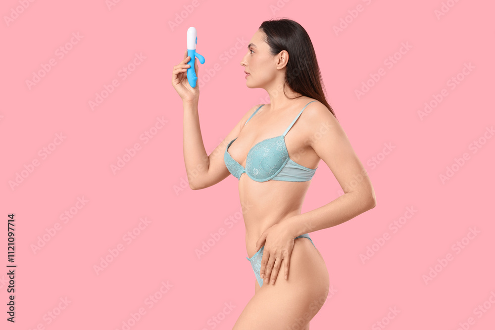 Beautiful young woman in underwear with vibrator from sex shop on pink background Beautiful young woman in underwear with vibrator from sex shop on pink background