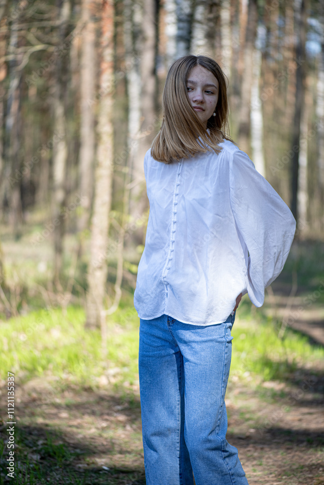 Young beautiful girl in a white shirt in the forest.