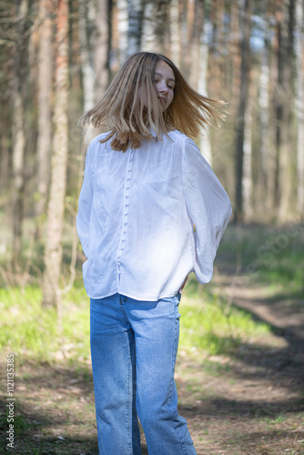 Young beautiful girl in a white shirt in the forest.