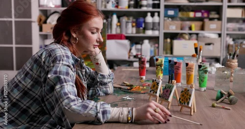 A Creative Artist in Their Studio Deep in Thought and Contemplating Their Artwork