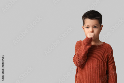 Ill little Asian boy coughi...