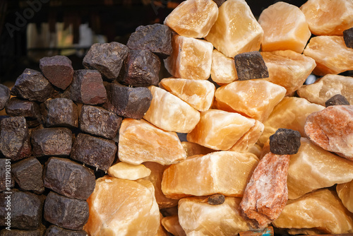 Himalayan rock salt and black salt stones, Natural edible salt stones, Organic rock salt blocks, Sendha namak close-up, Black salt and pink salt minerals, Raw Himalayan salt crystals stock photo. photo