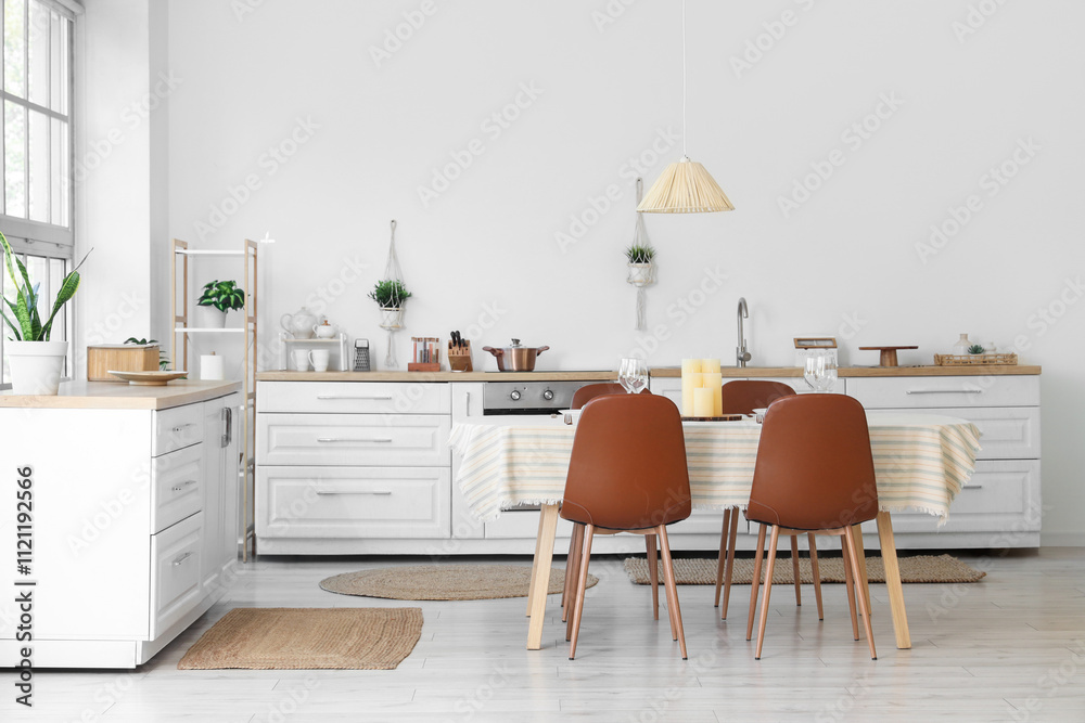 Fototapeta premium Beautiful table setting with candles in kitchen