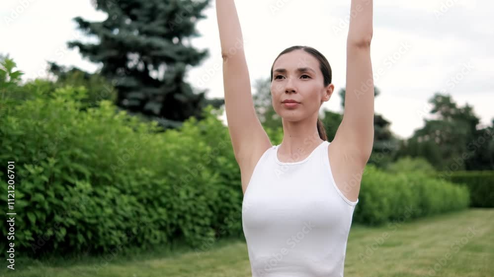 Young woman engaging in yoga poses within a tranquil park, promoting health and wellness amidst a natural environment Young woman engaging in yoga poses within a tranquil park, promoting health and wellness amidst a natural environment