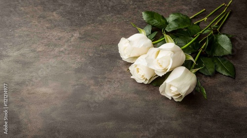 Fototapeta Naklejka Na Ścianę i Meble -  A delicate arrangement of white roses on a textured surface, symbolizing purity and elegance.