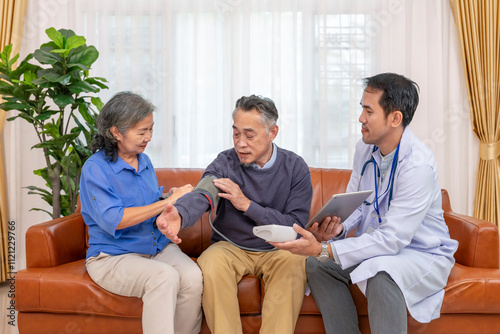 a nurse or doctor using digital tablet to teach senior wife measuring blood pressure an old man patient at home,elderly health care,personal care services,home health care