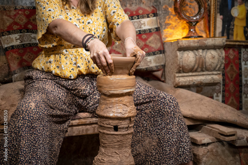 craftswoman handas molds a clay pot, handicraft workshop, clay molding lathe, typical artisan workshop in Turkey photo