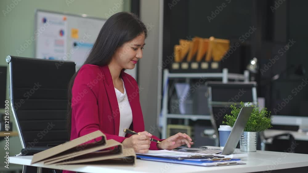Business woman or financial data analysts working with alculator and laptop computers and data graphs together. Plan to analyzing projects in the office. Business woman or financial data analysts working with alculator and laptop computers and data graphs together. Plan to analyzing projects in the office.