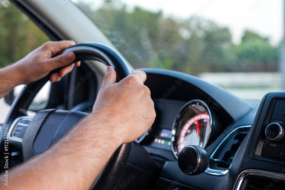 male driver is driving a car during a traffic jam in the capital. driving on the left male driver is driving a car during a traffic jam in the capital. driving on the left