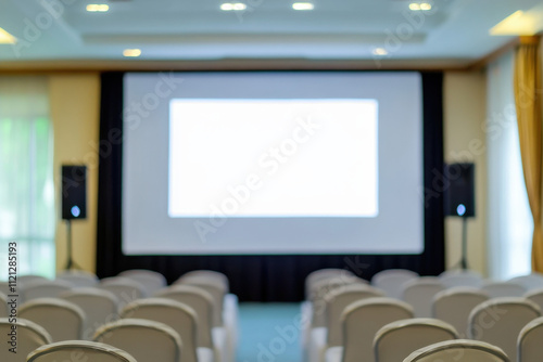 Empty conference room with a large projection screen and rows of chairs facing forward, creating a professional and formal atmosphere. photo