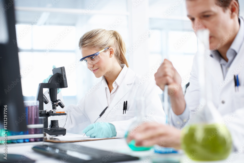 Research, man and woman in laboratory with microscope, collaboration and technology in science study. Solution, scientist and medical team in biotech, pharmaceutical innovation or vaccine development