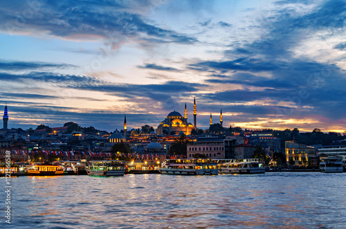 view from a pleasure boat on the Bosphorus and the cityscape of Istanbul, Turkey, the architecture of the city at sunset, a popular tourist destination.
