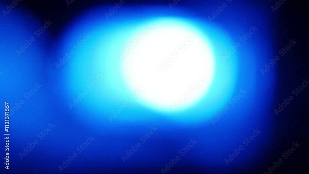 Seamless loop of blurred emergency blue flashing lights