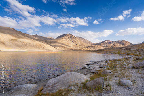 Scenic landscape view of high altitude mountain lake before sunset between Khargush pass and Pamir Highway, Murghab, Gorno-Badakhshan, Tajikistan photo