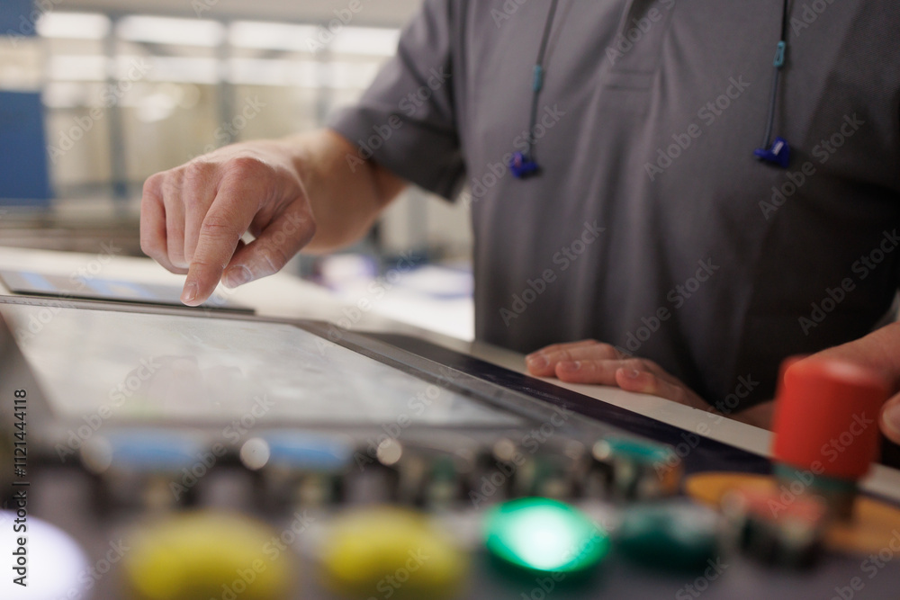 Industry Worker midsection with hand on screen Industry Worker midsection with hand on screen