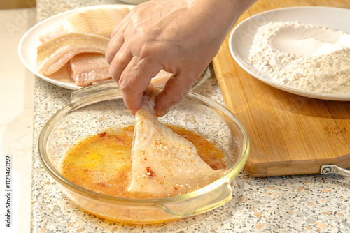 Wallpaper Mural Chef dips a piece of fish into liaison - a mixture of raw eggs, salt, paprika before frying Torontodigital.ca