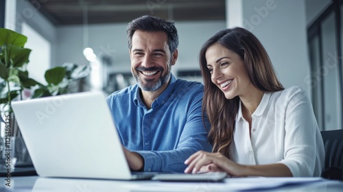 Male and female colleagues working on laptops in the office