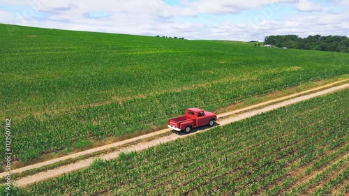 Old truck driving on country road 