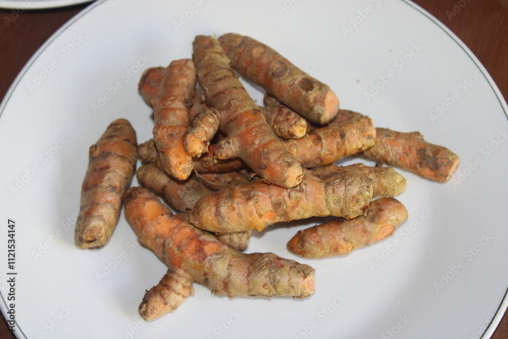 Fresh turmeric on white plate. Ingredients for making traditional medicine Fresh turmeric on white plate. Ingredients for making traditional medicine