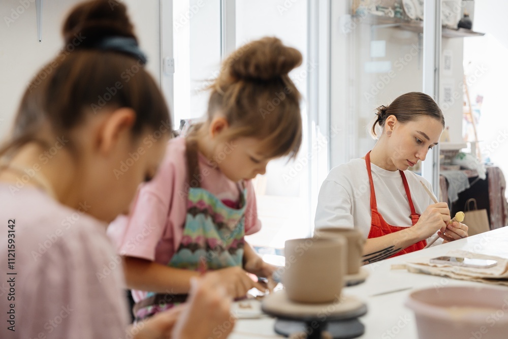 Artistic pottery class with children and adults engaged in creative activities Artistic pottery class with children and adults engaged in creative activities