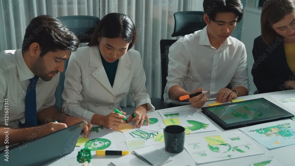 Professional engineer team in casual cloth talking about turbine engine structure at table with metal gear, calculator, sticky notes. Group of technician standing and attend in meeting. Alimentation.