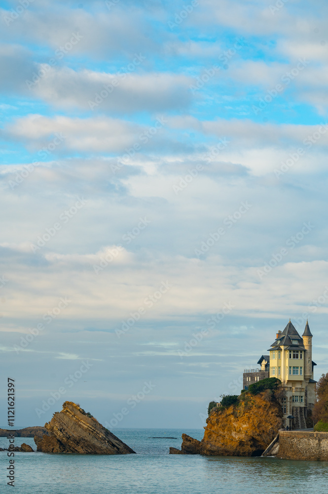 woman watching the sunset with her dog in Biarritz woman watching the sunset with her dog in Biarritz