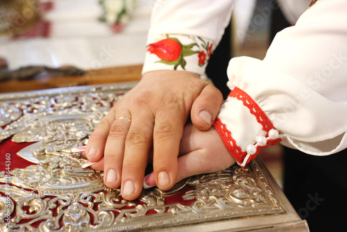 The newlyweds put their hands on the Gospel, making marriage vows. photo