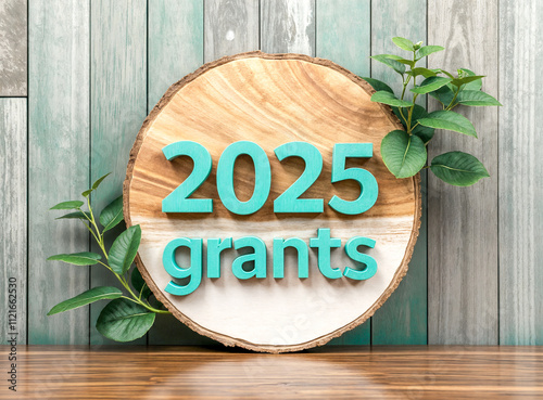 2025 grants: teal lettering on wooden slice with greenery photo