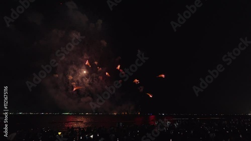Colorful fireworks light up the night sky over the beach
