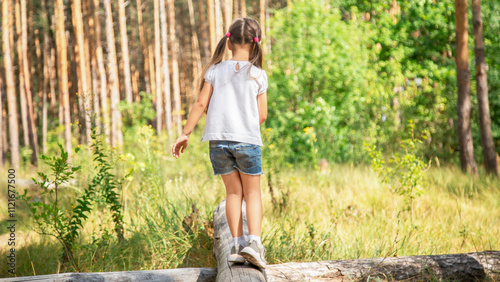 Kid in Forest Walking on Tree Log, Child Playing in Park, Tourist Adventure Girl in forest Children in Camp Trip photo
