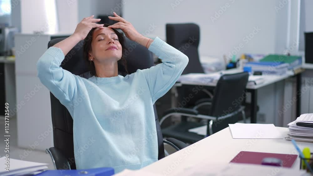 A focused professional woman typing diligently on a laptop while seated in a sleek, modern office environment A focused professional woman typing diligently on a laptop while seated in a sleek, modern office environment