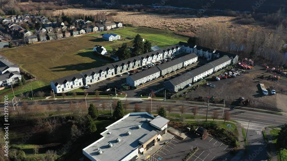 A smooth aerial video showcasing a modern residential complex in Vancouver, WA. The footage highlights neatly arranged townhouses surrounded by open land, reflecting suburban development trends A smooth aerial video showcasing a modern residential complex in Vancouver, WA. The footage highlights neatly arranged townhouses surrounded by open land, reflecting suburban development trends