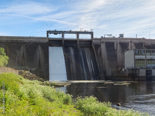 Water dam close view construction surrounded by grass