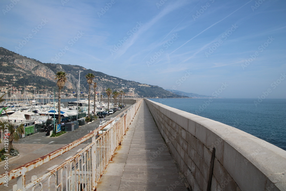 Fototapeta premium Pathway in the coastline, next to the fortified wall of Menton, French Riviera.